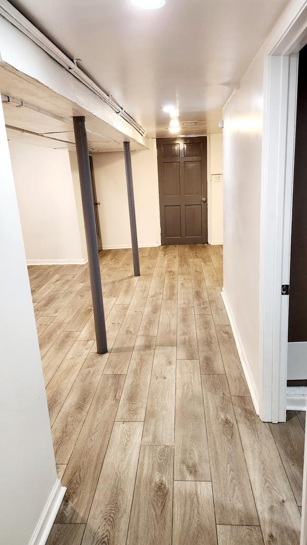 basement with light hardwood / wood-style flooring