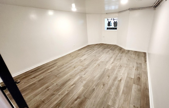 empty room with light hardwood / wood-style flooring