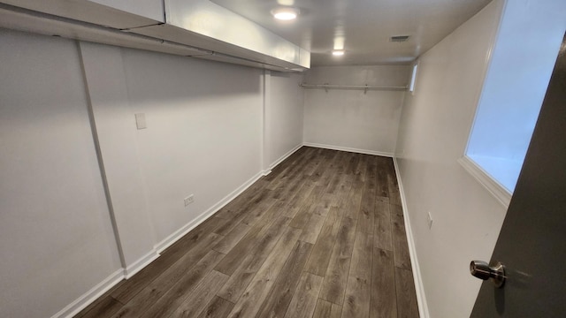 spacious closet with dark hardwood / wood-style flooring