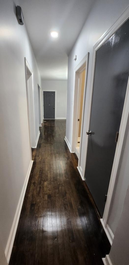 corridor featuring dark wood-type flooring