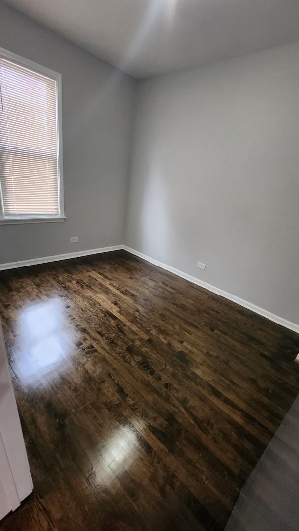 empty room with dark hardwood / wood-style floors