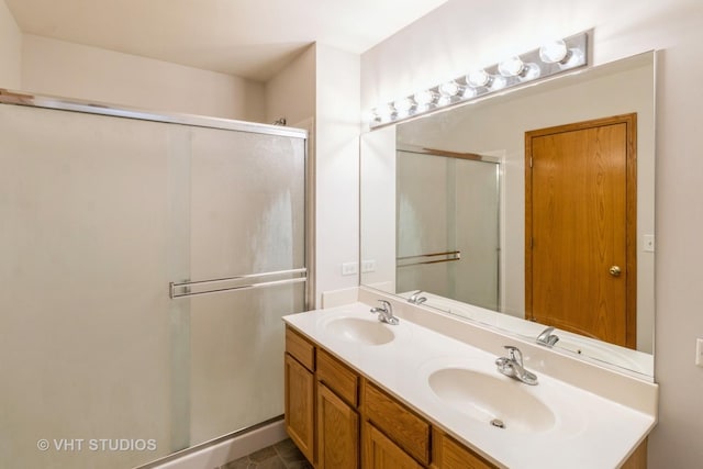 bathroom featuring vanity and a shower with shower door