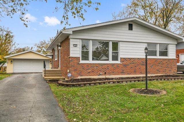 view of front of house with an outbuilding, a front lawn, and a garage