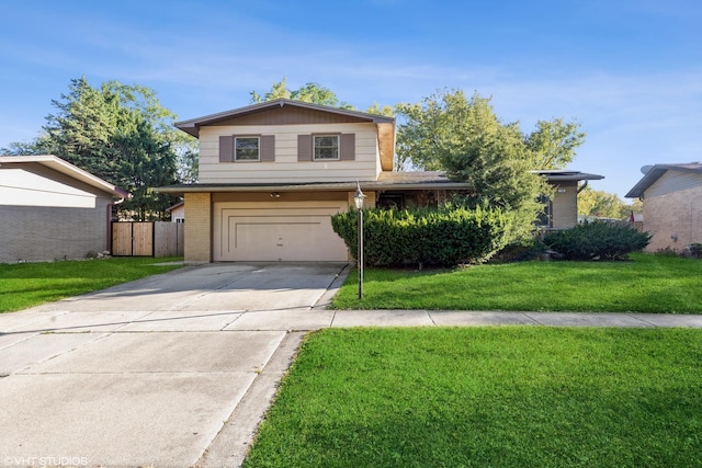 front facade featuring a front lawn and a garage