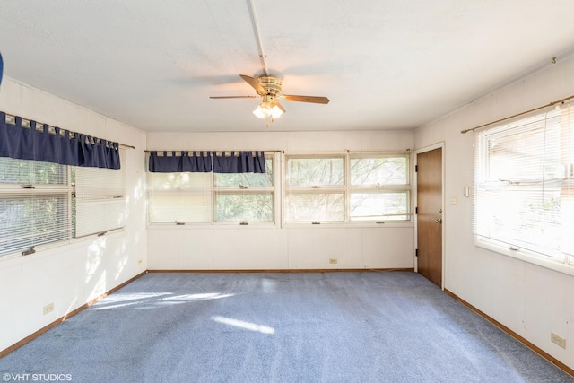 spare room featuring ceiling fan and carpet floors