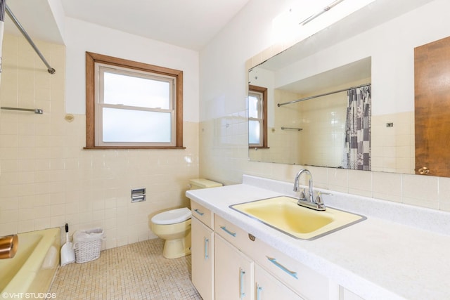 full bathroom featuring toilet, vanity, tile patterned floors, and tile walls