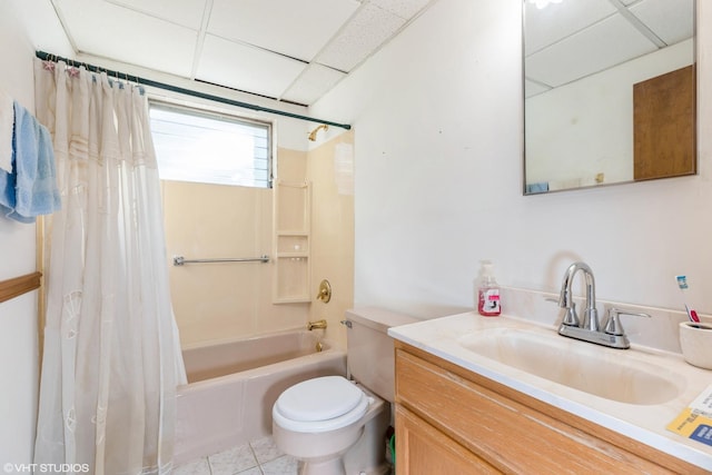 full bathroom featuring shower / tub combo, a paneled ceiling, vanity, tile patterned flooring, and toilet