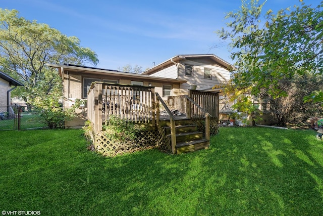 back of house with a lawn and a wooden deck