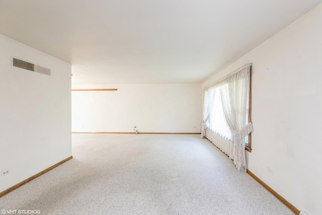 spare room featuring light carpet