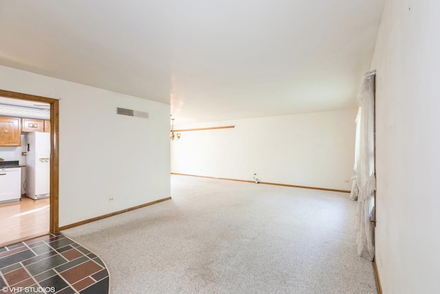 unfurnished living room with dark colored carpet