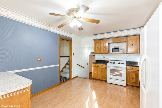 kitchen with white appliances, light hardwood / wood-style floors, and ceiling fan