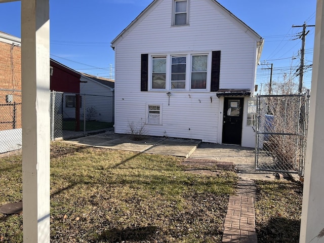 back of property featuring a lawn and a patio area