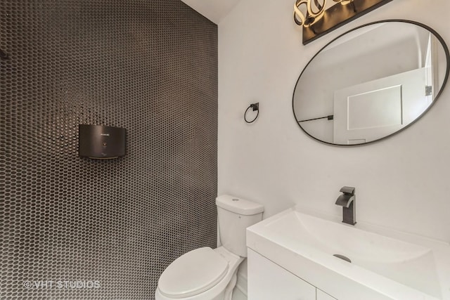 bathroom featuring toilet and vanity