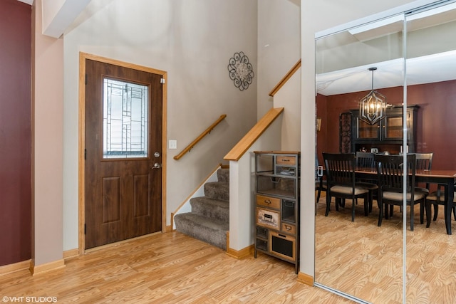 entrance foyer featuring hardwood / wood-style floors and a notable chandelier