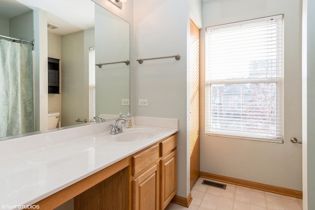 bathroom featuring vanity and toilet