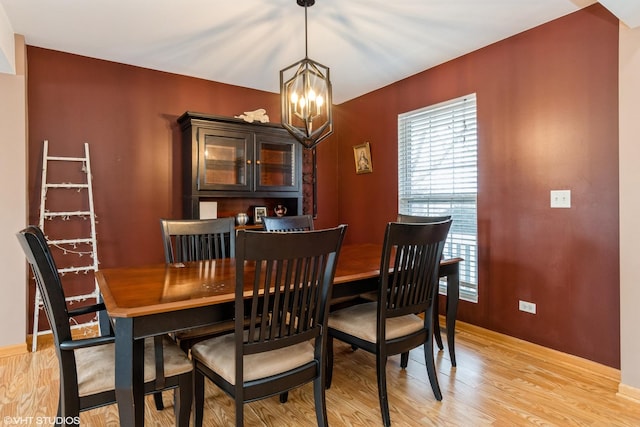 dining space featuring a notable chandelier and light hardwood / wood-style flooring