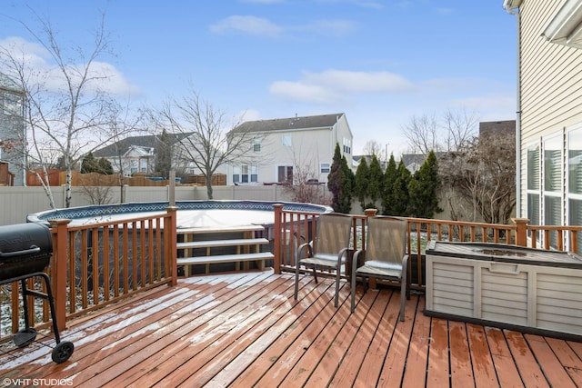 wooden deck with a fenced in pool