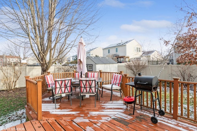 snow covered deck featuring grilling area