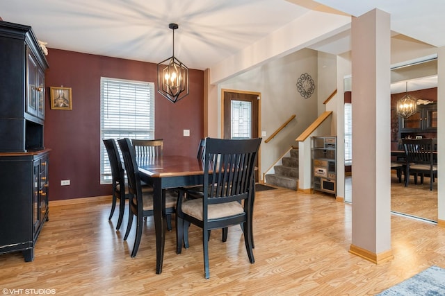 dining room featuring light hardwood / wood-style flooring and an inviting chandelier