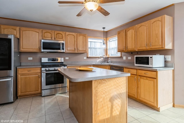 kitchen featuring stainless steel appliances, sink, pendant lighting, a center island, and light tile patterned flooring