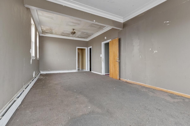 empty room featuring crown molding and a baseboard heating unit