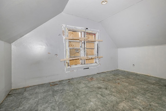 additional living space featuring lofted ceiling