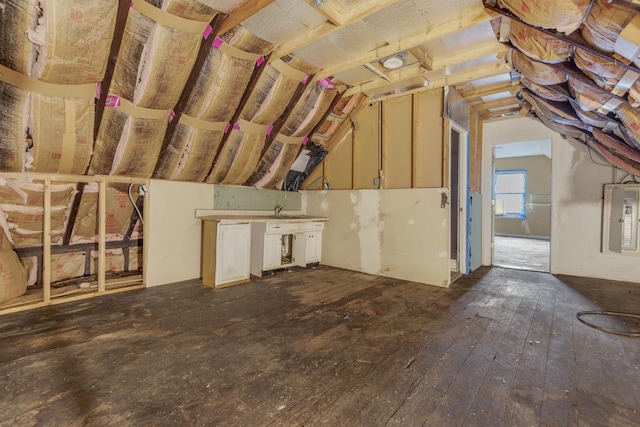 unfinished attic with electric panel and sink