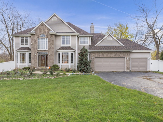 view of front of property featuring a front yard and a garage