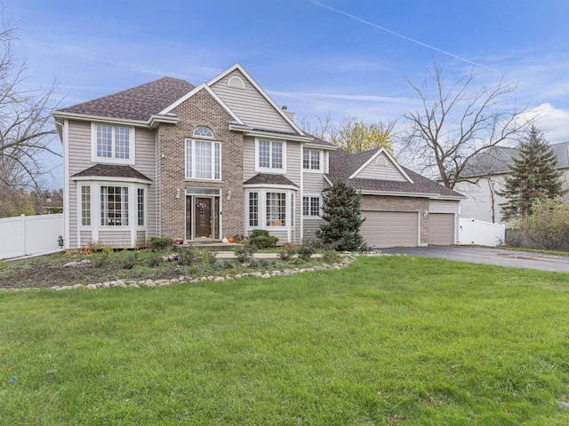 view of front of home featuring a garage and a front lawn