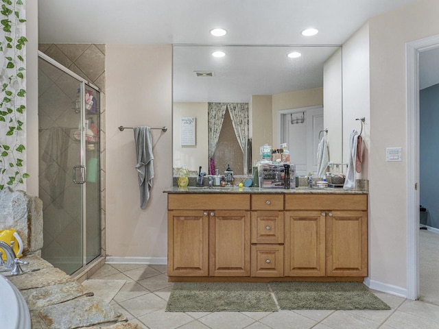 bathroom featuring vanity, tile patterned floors, and a shower with shower door