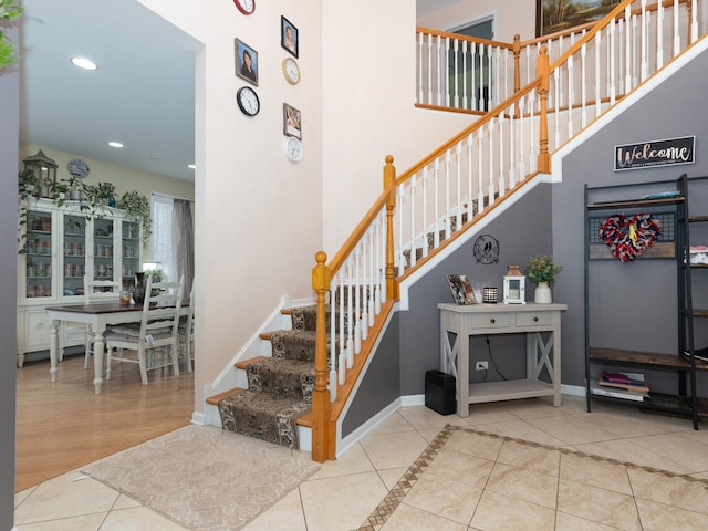 staircase featuring tile patterned flooring