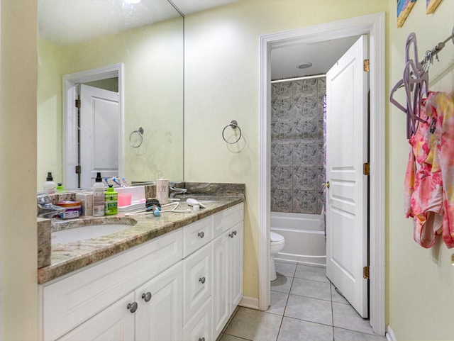 full bathroom featuring tile patterned flooring, vanity, toilet, and tiled shower / bath combo