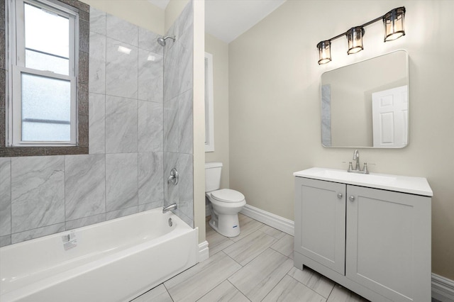 full bathroom with vanity, tiled shower / bath combo, and toilet