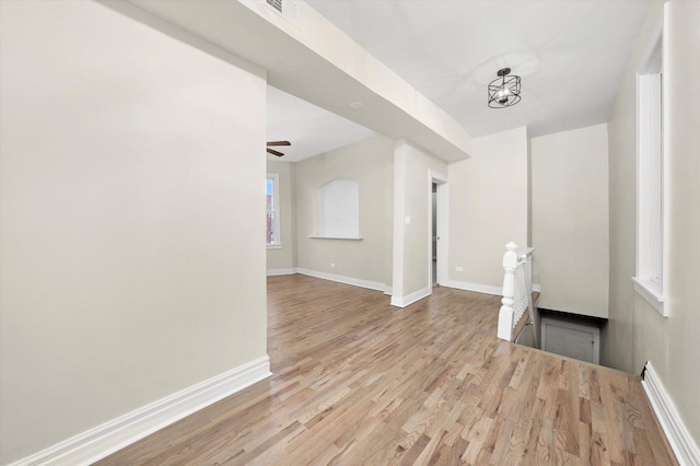 unfurnished living room with ceiling fan and light hardwood / wood-style floors