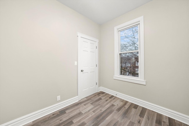 spare room with wood-type flooring