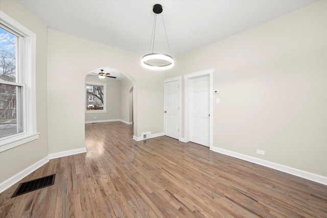 unfurnished dining area featuring hardwood / wood-style floors and ceiling fan