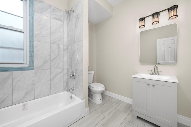 full bathroom featuring vanity, tiled shower / bath, and toilet