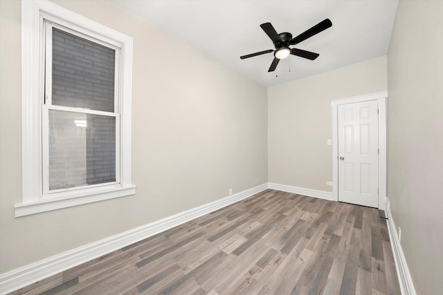 empty room with hardwood / wood-style flooring and ceiling fan