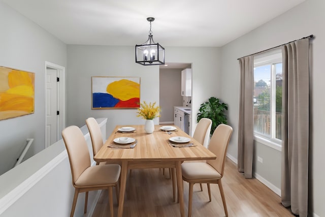 dining room featuring an inviting chandelier and light wood-type flooring