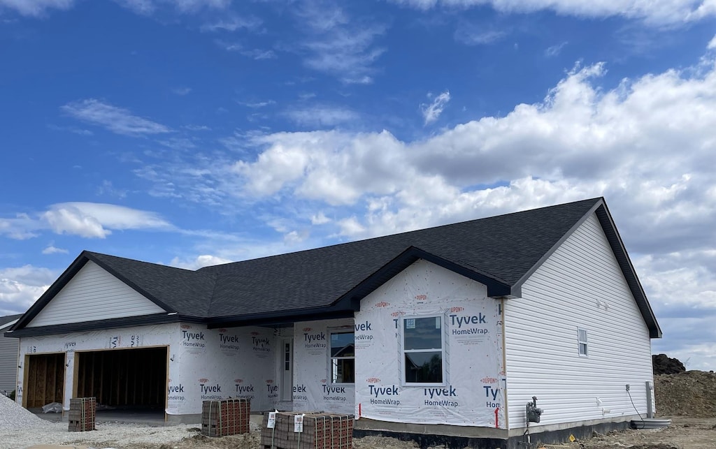 525 Lloyd Dr, Dwight, IL 60420 - property under construction with a garage, covered porch, a shingled roof, and central AC unit
