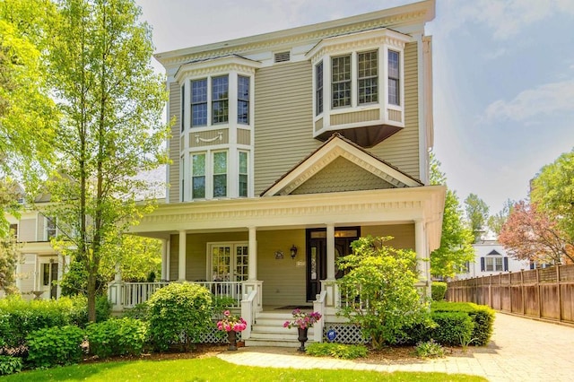 italianate house with covered porch and fence