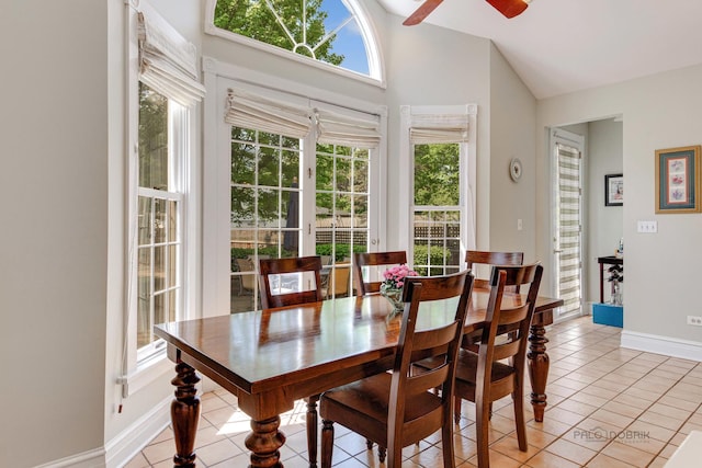 dining room with light tile patterned floors, ceiling fan, baseboards, and a wealth of natural light