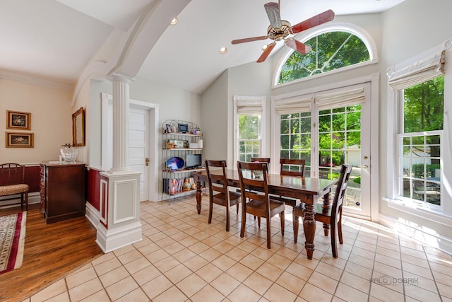 dining room with a healthy amount of sunlight, light tile patterned floors, and decorative columns