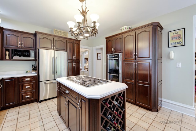 kitchen featuring pendant lighting, light tile patterned floors, stainless steel appliances, light countertops, and a kitchen island