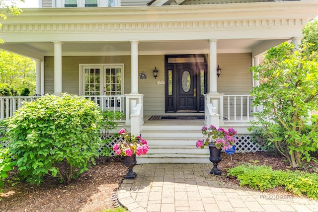 view of exterior entry with a porch