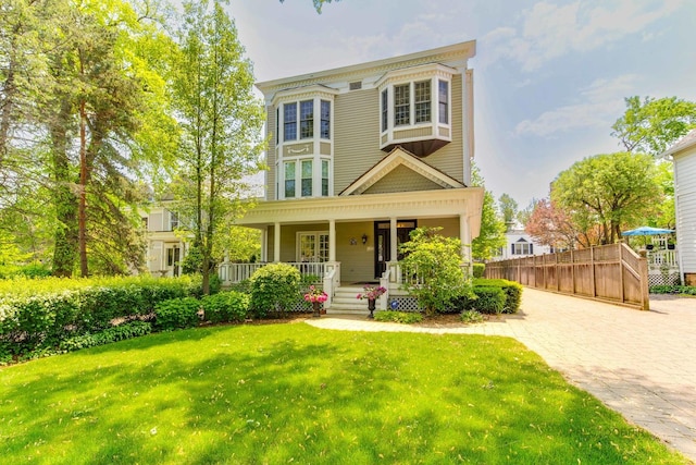 view of front of house featuring a porch and a front yard