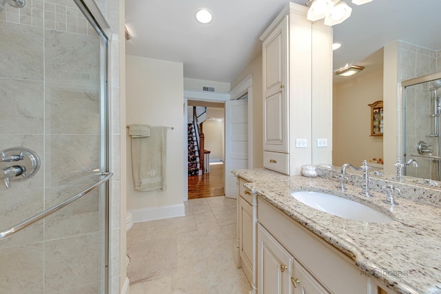 full bathroom with recessed lighting, visible vents, vanity, baseboards, and a shower stall