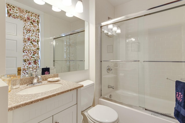 full bathroom with toilet, combined bath / shower with glass door, and vanity