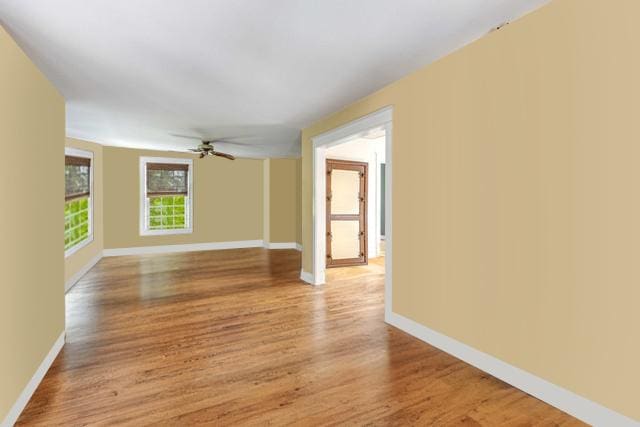 unfurnished room with light wood-type flooring, ceiling fan, and baseboards