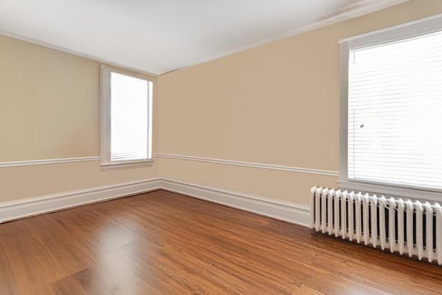 bathroom featuring vanity, a baseboard heating unit, tile patterned floors, and walk in shower